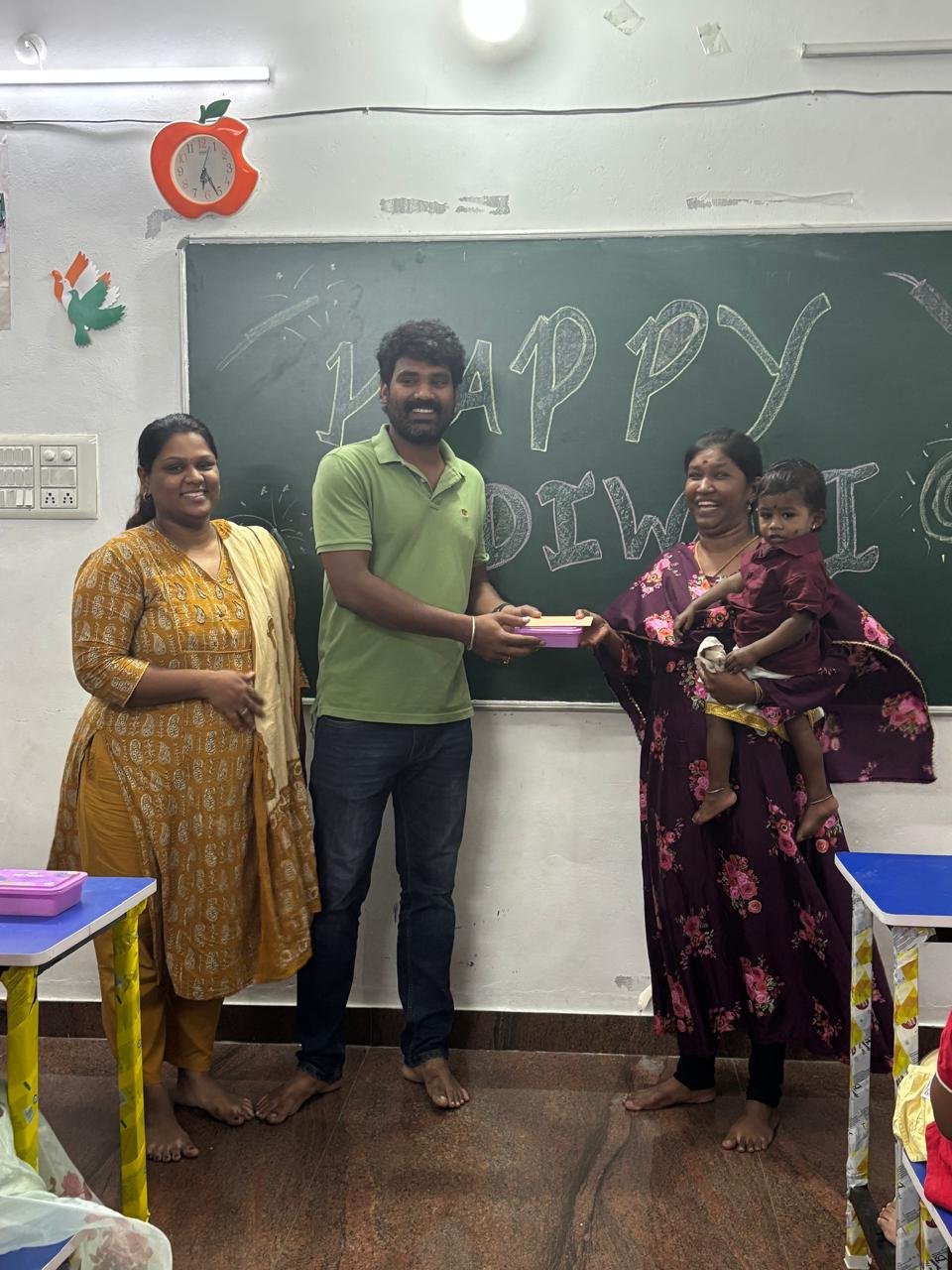 Students celebrating together in a classroom at Kanavugal Academy