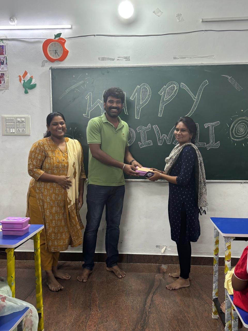Students celebrating together in a classroom at Kanavugal Academy