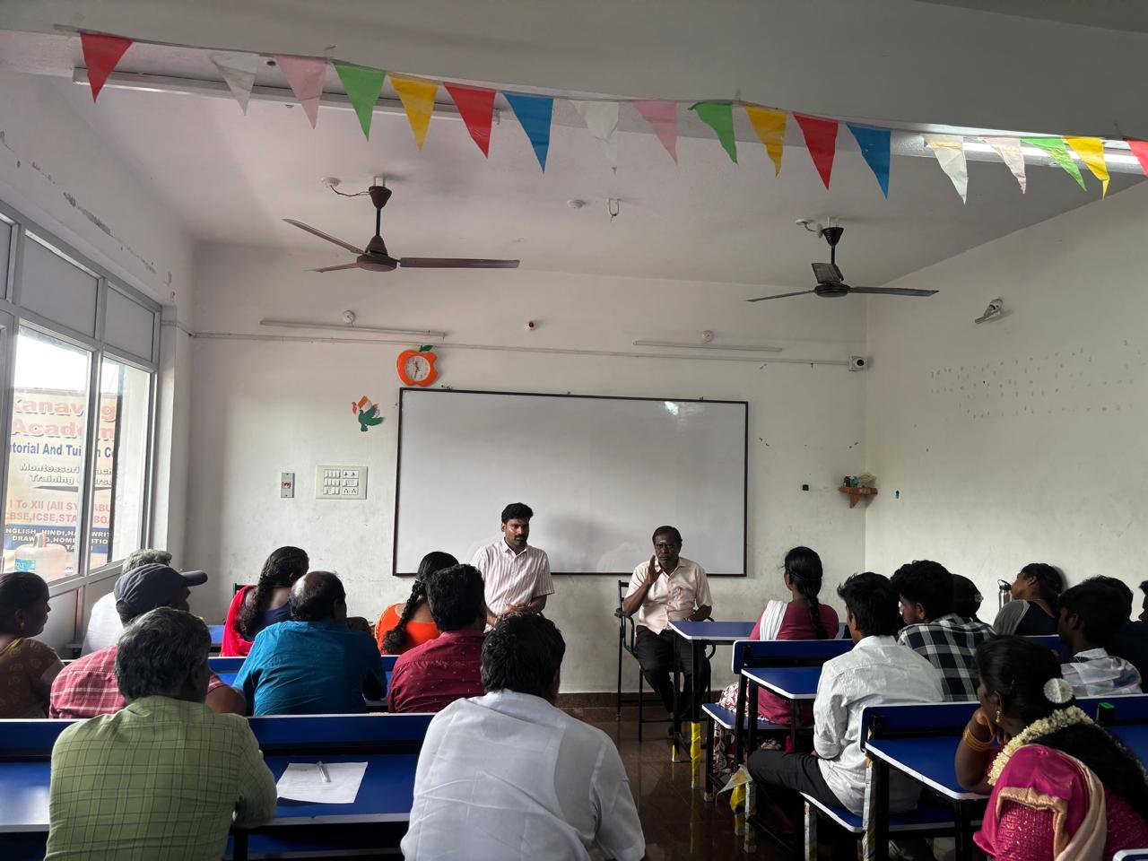 Students celebrating together in a classroom at Kanavugal Academy