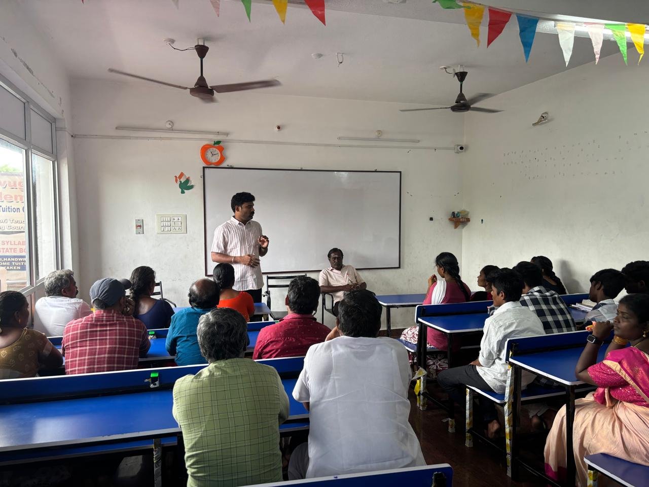 Students celebrating together in a classroom at Kanavugal Academy