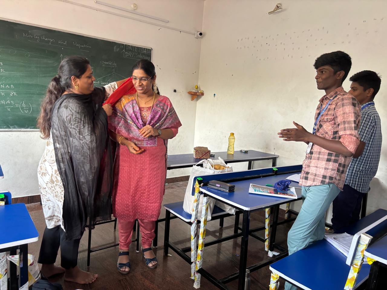 Students celebrating together in a classroom at Kanavugal Academy