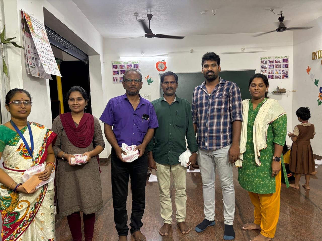 Students celebrating together in a classroom at Kanavugal Academy