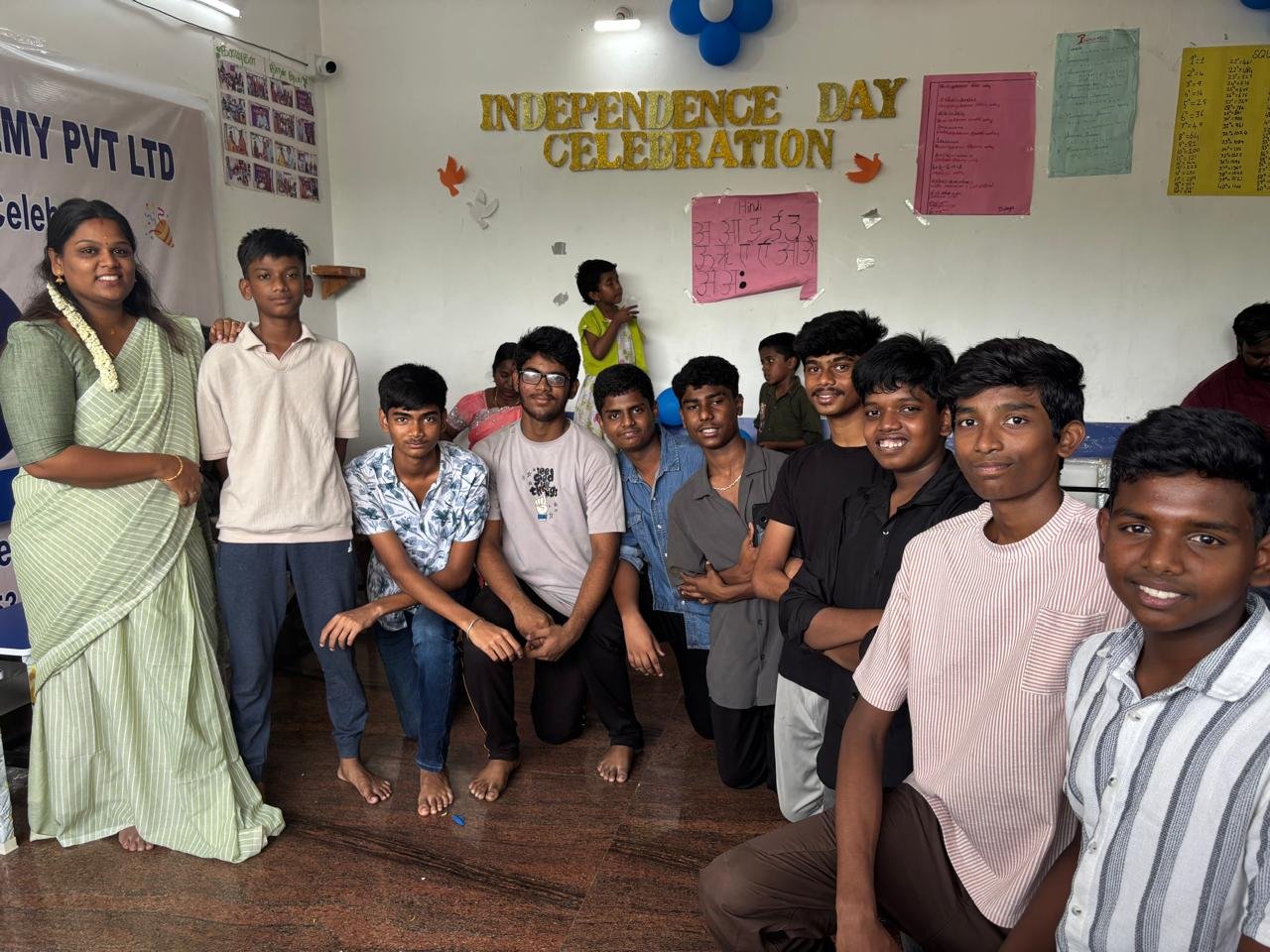 Students celebrating together in a classroom at Kanavugal Academy